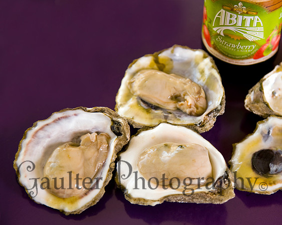 Oysters on a purple background with a Strawberry Abita Beer