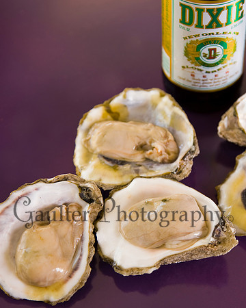 Oysters on purple background with a Dixie Beer in a vertical format